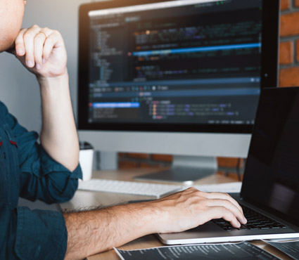 An IT professional sits at their desk providing remote IT support
